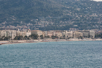 Sea by buildings in city