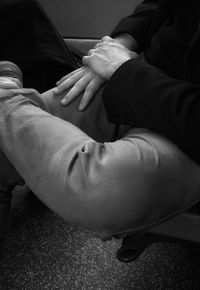 Low section of man sitting on floor