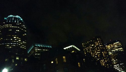 Low angle view of modern buildings against sky at night