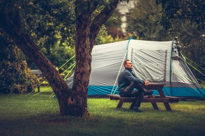 Man sitting on picnic table at park