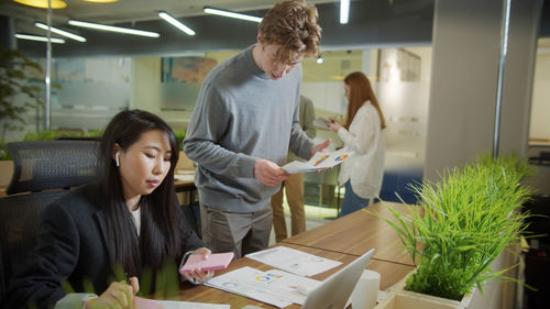 People looking at potted plants