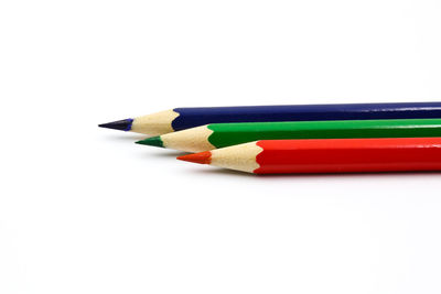 Close-up of colored pencils against white background