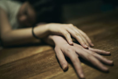 Close-up of woman hand on floor at home