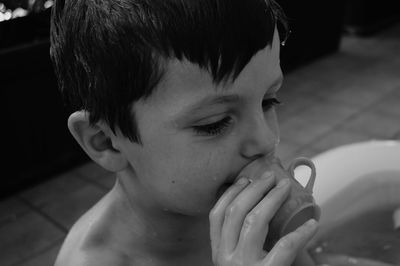 Close-up of cute boy in bathtub at home