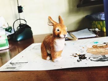 Close-up of rabbit statue on cardboard
