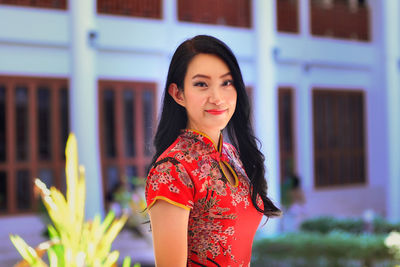 Portrait of a smiling young woman standing outdoors