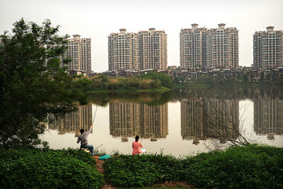 Reflection of trees and buildings in water