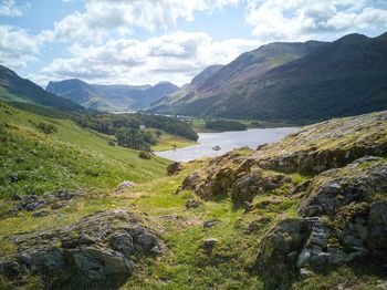 Scenic view of river and mountains against sky