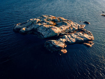 Aerial view of a small island in evening sun.