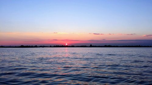 Scenic view of sea against sky at sunset