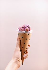 Close-up of hand holding ice cream cone