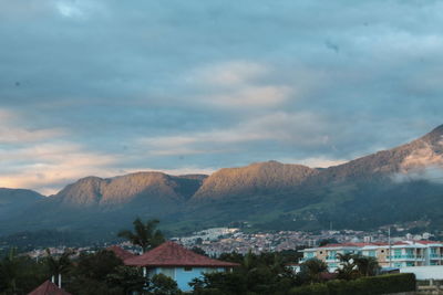 Town by mountains against sky