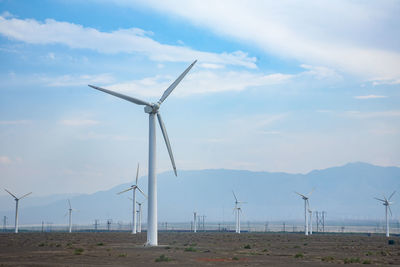 Windmill on field against sky