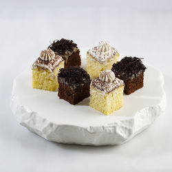 Vanilla and mocca sponge cake slice or cake potong on white stone plate