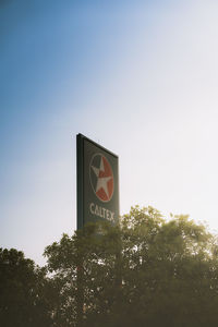 Low angle view of road sign against sky