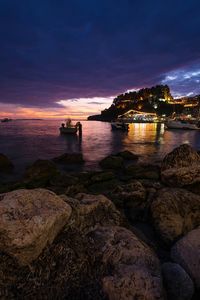 Scenic view of bay against sky at sunset