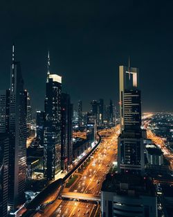 High angle view of illuminated buildings against sky at night