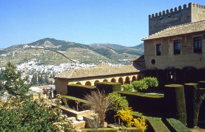 Houses on mountain against clear sky