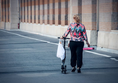 Rear view of women walking on road