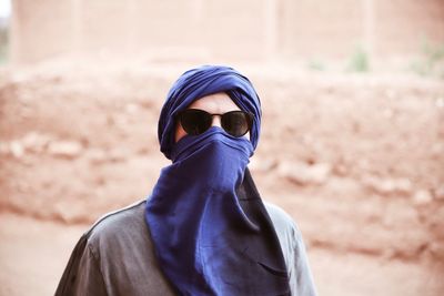 Portrait of man wearing sunglasses and scarf