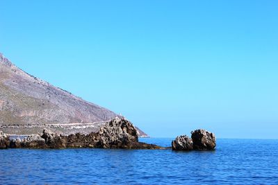 Scenic view of sea against clear blue sky