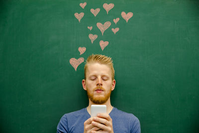Portrait of young man holding camera