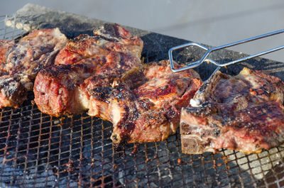 High angle view of meat on barbecue grill