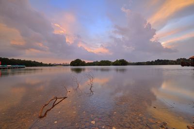 Scenic view of lake against sky at sunset