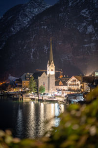 Wonderful small church on bank of a lake illuminated during night, detail, hallstatt, austria