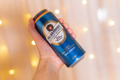 Close-up of human hand holding illuminated text