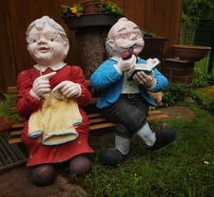 High angle view of father with toy sitting in yard