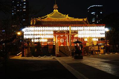 Illuminated building against sky at night