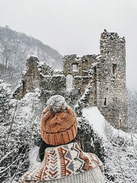 Rear view of person in snow against sky