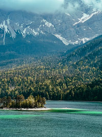 Scenic view of sea and mountains against sky