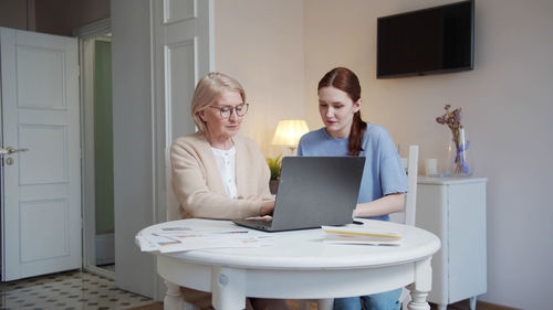 Young woman using laptop at home