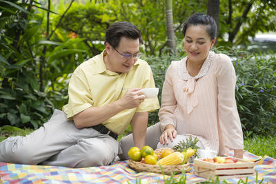 Young couple sitting on table outdoors