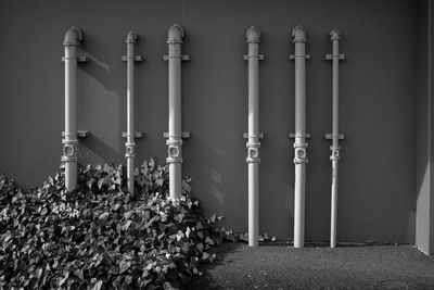 Row of pipes against wall