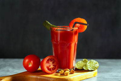 Bloody mary cocktail in glass served with tomatoes and pickles. red cocktail. dirty dump drink