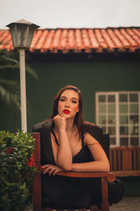 Portrait of a young woman sitting outdoors