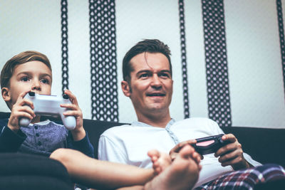 Portrait of happy man holding camera