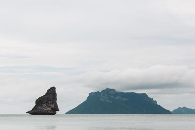 Scenic view of sea and mountains against sky