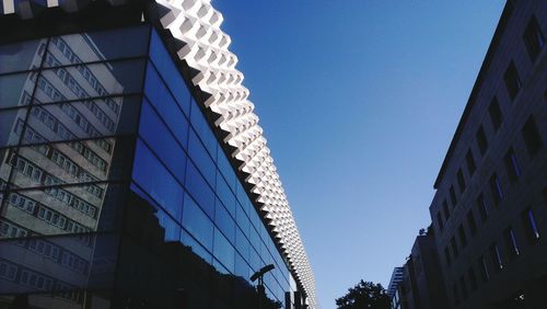 Low angle view of building against clear blue sky