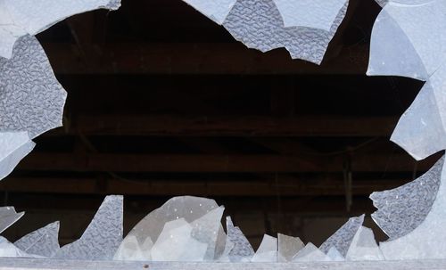 Close-up of broken roof against building