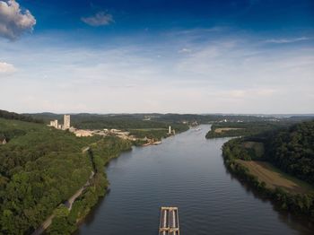 Scenic view of river against sky as a barge passes