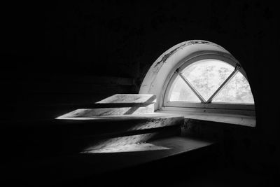 Sunlight streaming through arch window on steps