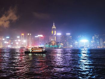 View of illuminated ship sailing in river at night