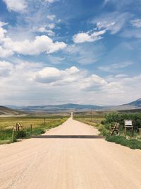 Narrow road along countryside landscape