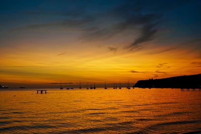 Scenic view of sea against orange sky