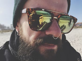 Close-up portrait of young man wearing sunglasses