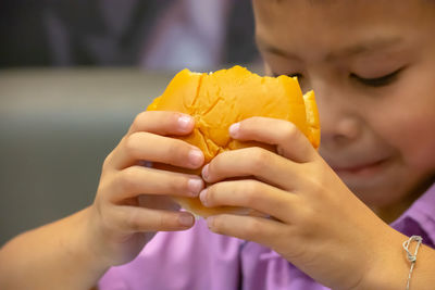 Close-up of boy eating burger